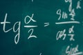 Tangent alpha sine cosine. Trigonometric formula written on the board. Royalty Free Stock Photo