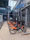 Toronto, Ontario, Canada - August 2, 2023 : Tangerine bikes lined up at the bike share station Infront of the Union railway