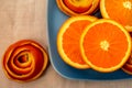 Tangerine on a blue plate with a decor of a peel citrus.
