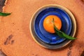 Tangerine on blue plate
