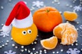 Tangerine with eyes in Santa hat, Christmas Xmas New Year concept, fresh ripe and sweet mandarin orange clementine tangerine Royalty Free Stock Photo