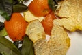 Tangerine peel with green leaves on white background