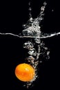 Tangerine splashing in fresh water