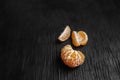 Tangerines on a black background. Lots of fresh fruit - mandarins. Royalty Free Stock Photo