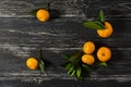 Tangerines on a black wooden background,top view. space for text. Royalty Free Stock Photo