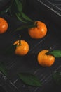 Tangerines on a black wooden stand. Photo with toning. Selective focus. Royalty Free Stock Photo