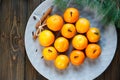 Tangerines bright orange ripe with green leaves on a gray plate with fir branches on the wooden table. table setting for Christmas Royalty Free Stock Photo