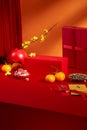 Tangerines, jam, sunflower seeds, lucky money envelopes, yellow apricot blossoms and red platform shine brightly in the