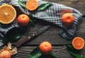 Tangerines with a knife on a wooden background. Healthy food. Fruit