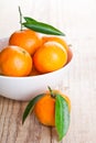 Tangerines with leaves in bowl Royalty Free Stock Photo
