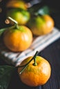 Tangerines with leaves on an old fashioned country table. Selective focus. Vertical.