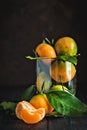 Tangerines with leaves on an old fashioned country table. Selective focus. Vertical.