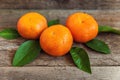 Tangerines with leaves on wooden background Royalty Free Stock Photo