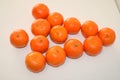 Tangerines lined in the shape of a Christmas tree on a white background