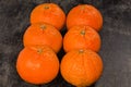 Tangerines Murcott on a black surface, close-up