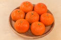 Tangerines Murcott on a wooden dish on a wooden surface