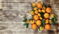 Tangerines oranges, mandarins, citrus fruits with leaves over rustic wooden background Royalty Free Stock Photo