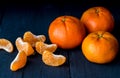 Tangerines on rustic black table close up - Citrus fruit background Royalty Free Stock Photo