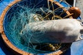 Tangle of blue nylon fishing line in drum with float