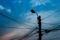 Tangle cable and electricity post on sunset background Royalty Free Stock Photo