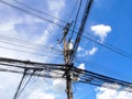 A tangle of cables and wires on high-voltage power pole Royalty Free Stock Photo