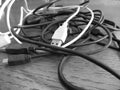 Tangle of dusty computer cables with sockets on the table . Black and white photo Royalty Free Stock Photo