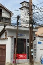 Tangle of electrical wires on a pylon in front of a house at Prizren in Kosovo