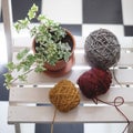 Tangle of thread on a wooden bench. Autumn picture. A white skein of yarn next to the leaf.