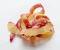 Tangled apple peelings laying on white background