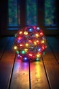 tangled ball of colorful christmas lights on a dark wooden table Royalty Free Stock Photo