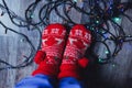 Tangled Christmas lights at feet on floor. Electricity expenses concept Royalty Free Stock Photo