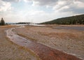 Tangled Creek running into Hot Lake under cumulus cloudscape in the Lower Geyser Basin in Yellowstone National Park in Wyoming USA