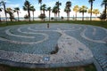 Tangled decorative path made with pebbles on the round stone cobblestone pavement at seaside park