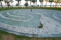 Tangled decorative path made with pebbles on the round stone cobblestone pavement