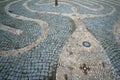 Tangled decorative path made with pebbles on the stone pavement