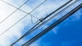 Tangled Electrical Wires Against a Bright Blue Sky Royalty Free Stock Photo