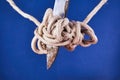 A tangled knot on a rope with a knife blade