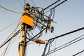 Tangled messy electrical wires on pole posing a safety hazard