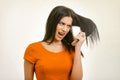 Tangled messy hairstyle problem. Woman brushing her damaged hair