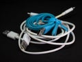 Tangled roll of USB wires over black background Royalty Free Stock Photo