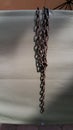 Hanging metal chains closeup on fabric background. Symbol of slavery