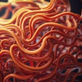 Tangled strands of bright orange and red fibers intertwine in an abstract, flowing pattern.