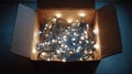Tangled string lights glowing inside cardboard box Royalty Free Stock Photo