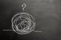 Tangled Tangle and Question Mark Drawn on Chalkboard. Psychotherapy illustration with hands and tangled thread Royalty Free Stock Photo