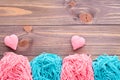 Tangles of pink and mint yarn and knitting hearts