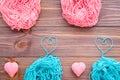 Tangles of pink and mint yarn and knitting hearts