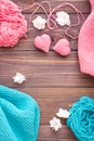 Tangles of pink and mint yarn, snuds and knitting hearts