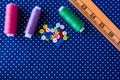 Tangles of threads and colored buttons on the blue fabric Royalty Free Stock Photo