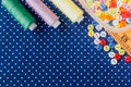 Tangles of threads and colored buttons on the blue fabric Royalty Free Stock Photo
