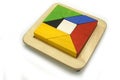 Tangram, Chinese traditional puzzle game made of different colorful wooden pieces that come together in a distinct shape Royalty Free Stock Photo